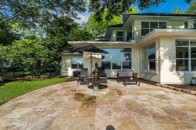 back of property featuring a patio area