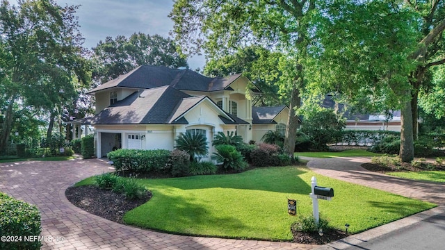 view of front of house with a garage and a front yard