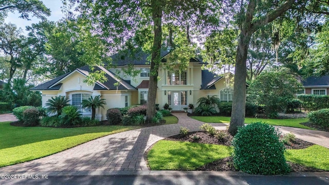 view of front facade with a front yard and french doors