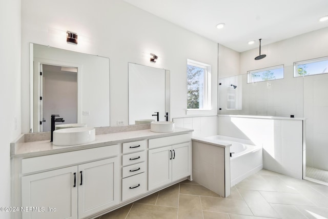 bathroom with tile patterned flooring, vanity, and independent shower and bath