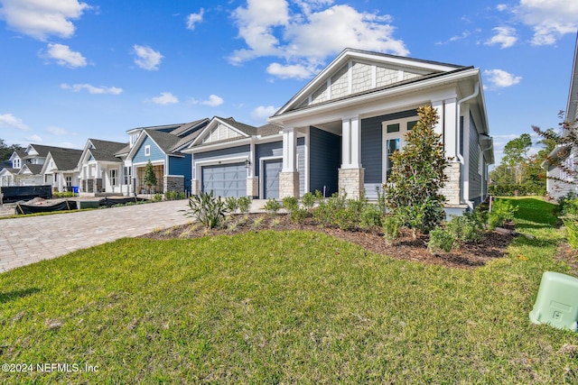 view of front of home with a front yard and a garage