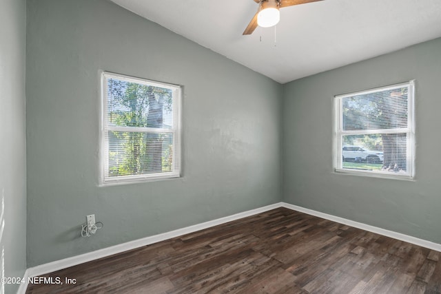 spare room with vaulted ceiling, ceiling fan, and dark wood-type flooring