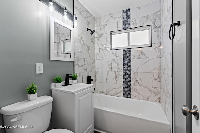 full bathroom with toilet, vanity, and tiled shower / bath