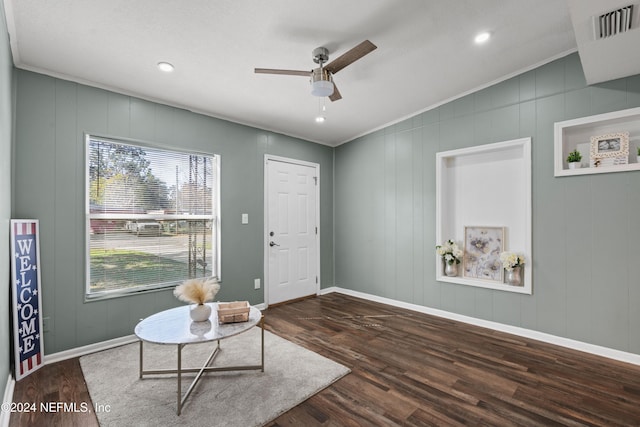 living area featuring ceiling fan, dark hardwood / wood-style floors, and ornamental molding