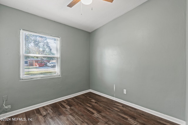 spare room featuring ceiling fan and dark wood-type flooring