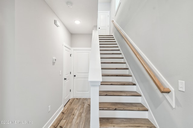 stairway featuring hardwood / wood-style floors