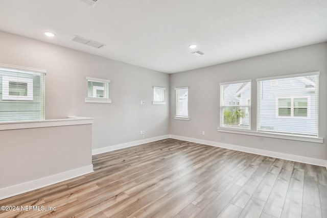 spare room with light hardwood / wood-style floors