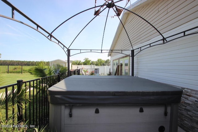 view of patio / terrace with a hot tub