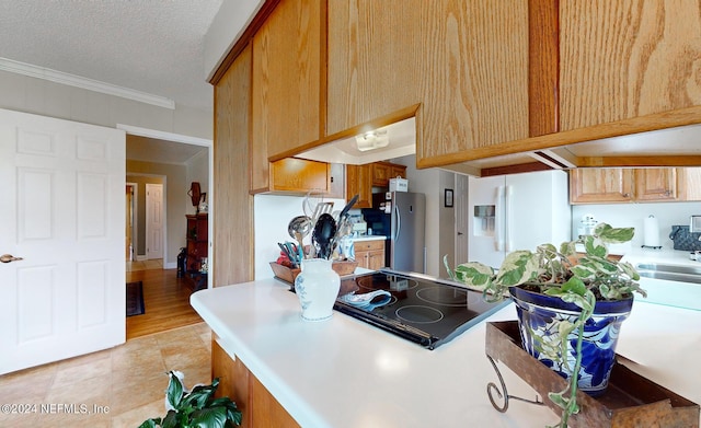 kitchen with white fridge with ice dispenser, a textured ceiling, stainless steel fridge, ornamental molding, and black electric cooktop