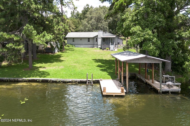 dock area with a lawn and a water view