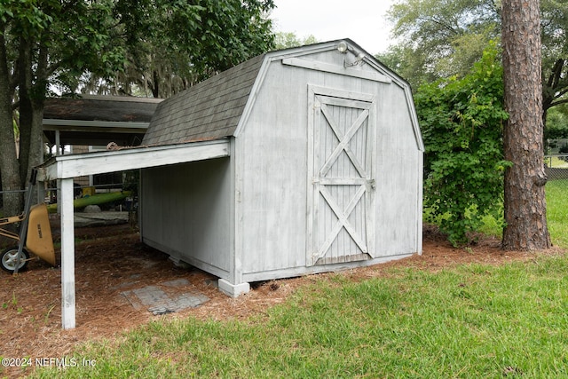 view of outbuilding featuring a lawn