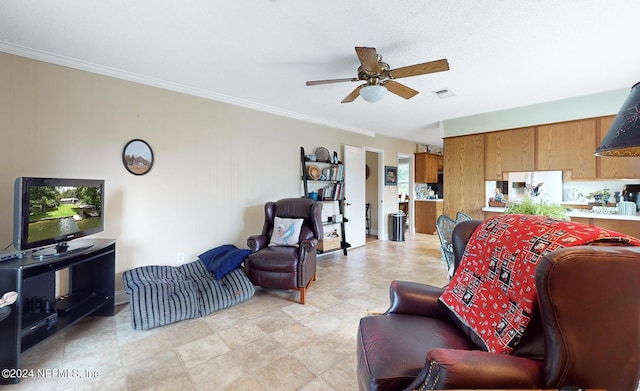 living room with ceiling fan and crown molding