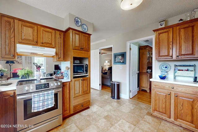 kitchen featuring a textured ceiling and stainless steel appliances