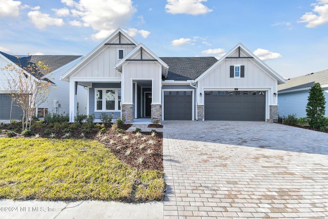 modern farmhouse with a front lawn and a garage