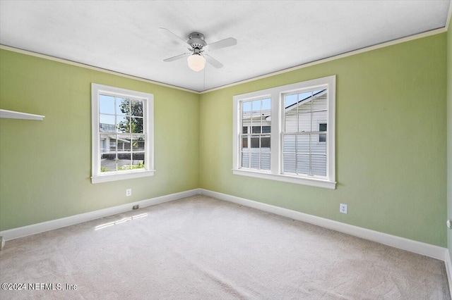 carpeted empty room with ornamental molding and ceiling fan