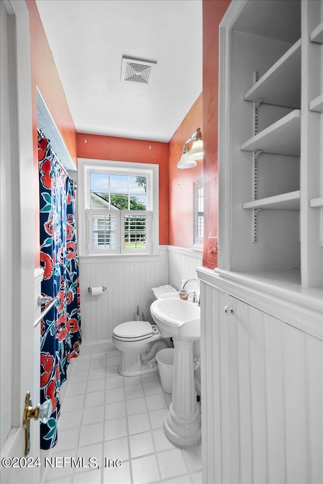 bathroom featuring tile floors and toilet