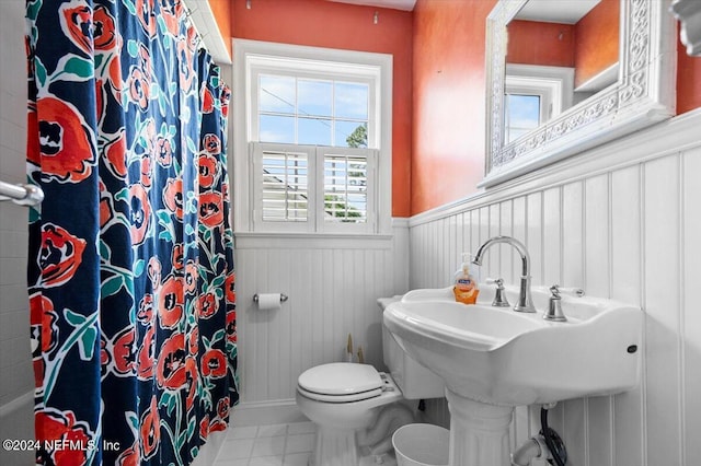 bathroom with tile flooring and toilet