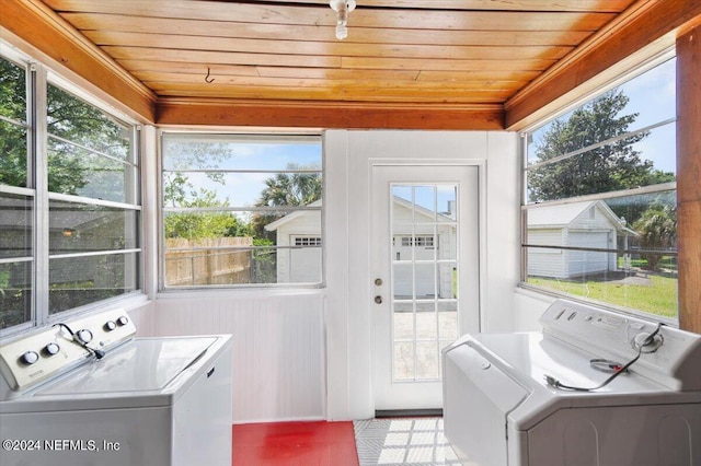 washroom with washer and clothes dryer and wood ceiling