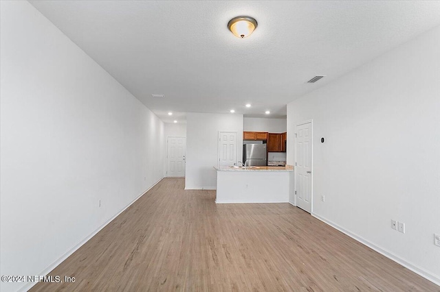 unfurnished living room featuring light wood-type flooring