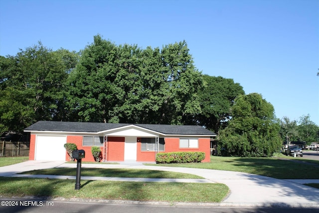 view of front of home with a garage and a front yard