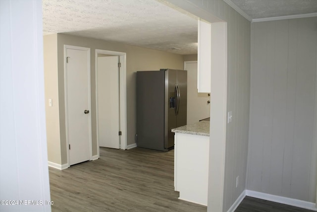 kitchen featuring white cabinetry, a textured ceiling, stainless steel fridge with ice dispenser, and dark wood-type flooring