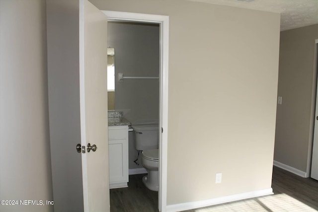 interior space featuring dark hardwood / wood-style flooring and connected bathroom