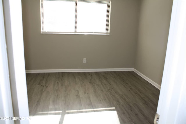 spare room with dark hardwood / wood-style flooring