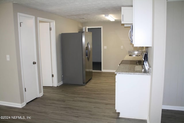 kitchen featuring white cabinetry, dark wood-type flooring, and stainless steel appliances