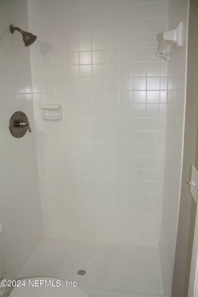 bathroom with tiled shower