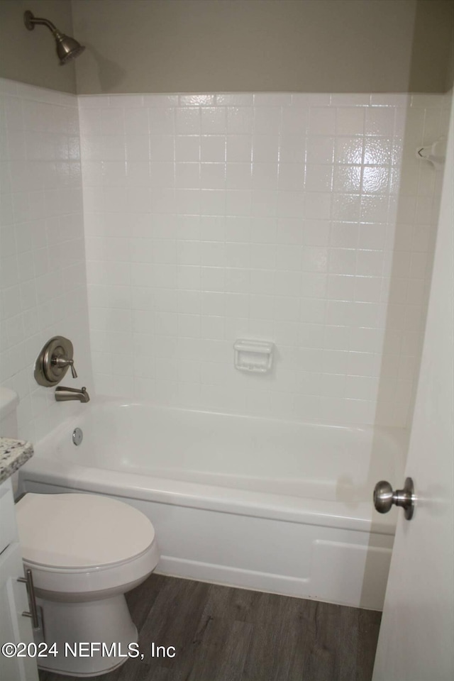 full bathroom with shower / bathing tub combination, hardwood / wood-style flooring, toilet, and vanity