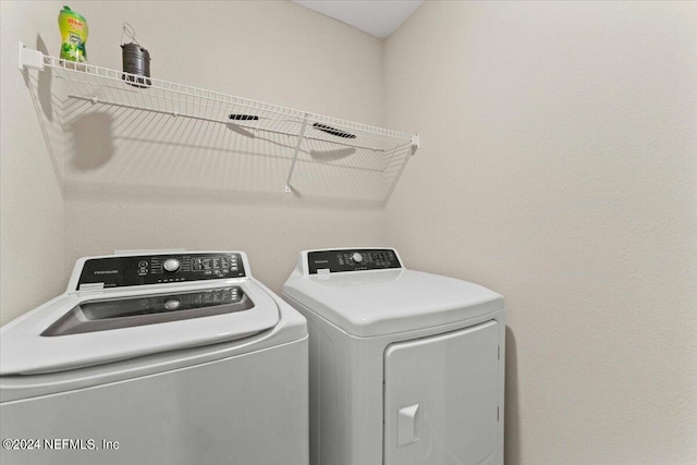 laundry room with washing machine and clothes dryer