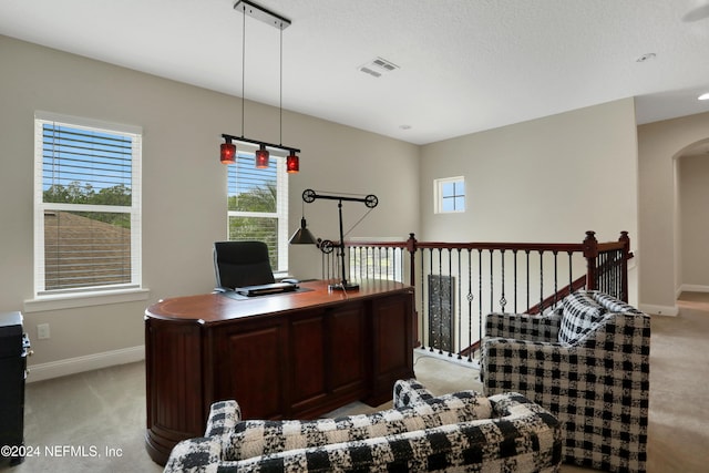 home office with baseboards, visible vents, light colored carpet, and arched walkways