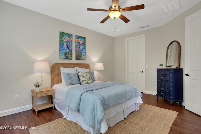 bedroom featuring baseboards, dark wood-style floors, a ceiling fan, and visible vents