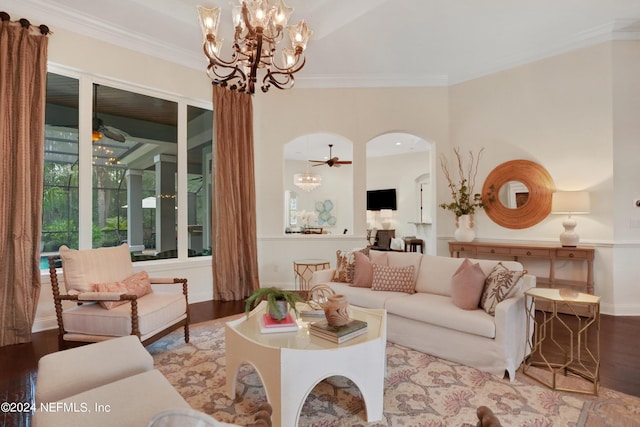 living area with ornamental molding, ceiling fan with notable chandelier, wood finished floors, and arched walkways