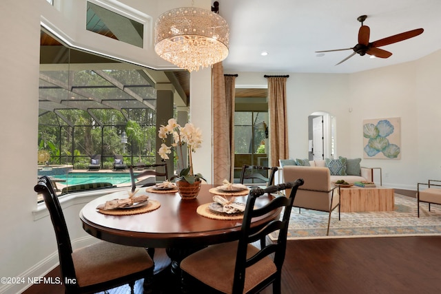 dining space with baseboards, a sunroom, wood finished floors, and recessed lighting