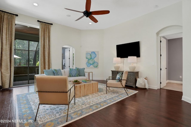 living room with ceiling fan, baseboards, arched walkways, dark wood-style flooring, and recessed lighting