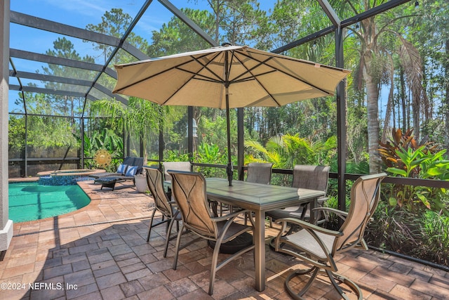 view of patio / terrace featuring a lanai and a pool with connected hot tub