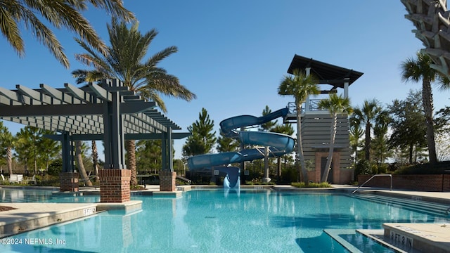 view of pool featuring a water slide and a pergola