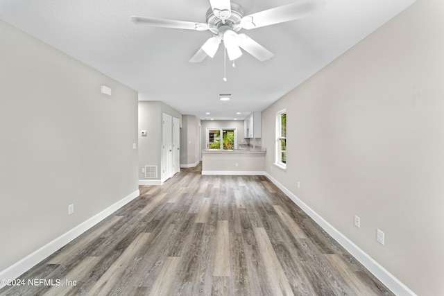 unfurnished room featuring hardwood / wood-style floors and ceiling fan