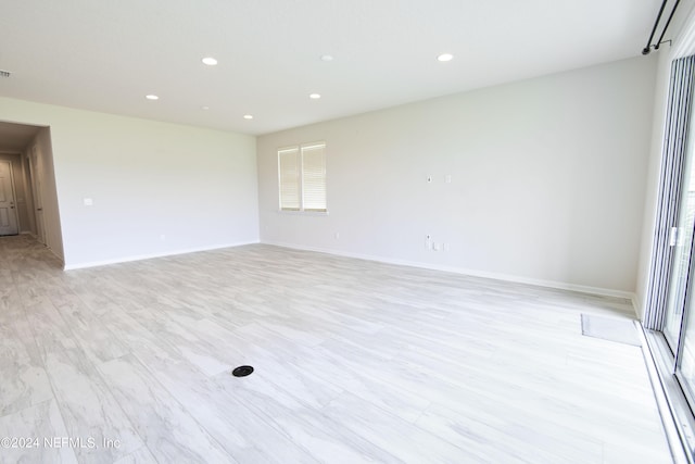 spare room featuring light hardwood / wood-style flooring