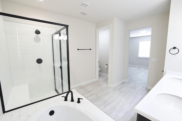 full bathroom featuring vanity, separate shower and tub, hardwood / wood-style floors, and toilet