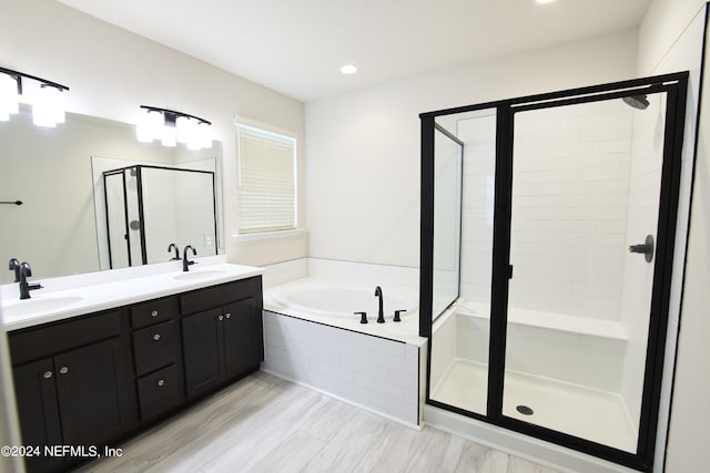 bathroom with vanity and separate shower and tub