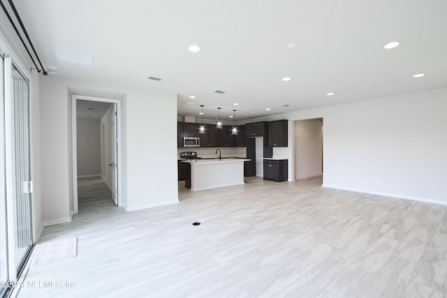 unfurnished living room with sink