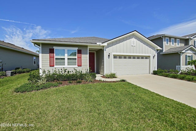 view of front of property with a garage and a front yard