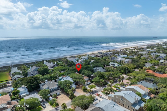 birds eye view of property with a beach view and a water view