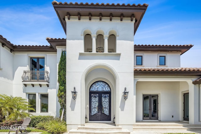 5275 Bentpine Cove Rd, Jacksonville, FL 32224 - entrance to property featuring french doors, a tile roof, stucco siding, and a balcony