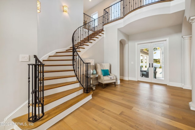 5275 Bentpine Cove Rd, Jacksonville, FL 32224 - foyer entrance featuring french doors, wood finished floors, stairs, a high ceiling, and baseboards