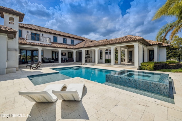 5275 Bentpine Cove Rd, Jacksonville, FL 32224 - rear view of property featuring a patio area, a balcony, a pool with connected hot tub, and stucco siding