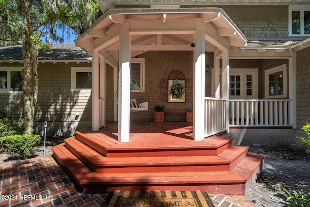 view of exterior entry with a porch