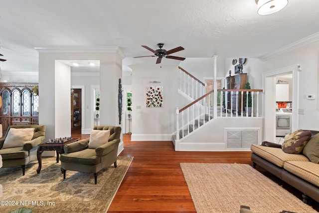 living room with ceiling fan, ornamental molding, and dark wood-type flooring